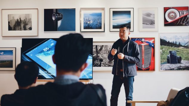 A man gives a presentation in front of a room.