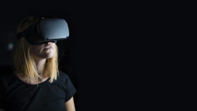 A woman uses a virtual reality headset