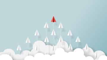 Paper airplanes flying from clouds on blue sky.Paper art style of business teamwork creative concept idea.Vector illustration. Leaders concept