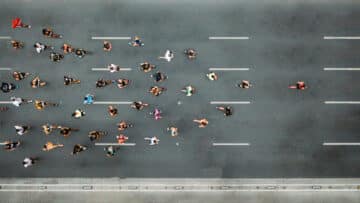 Aerial view of marathon city runners. One person leading marathon.