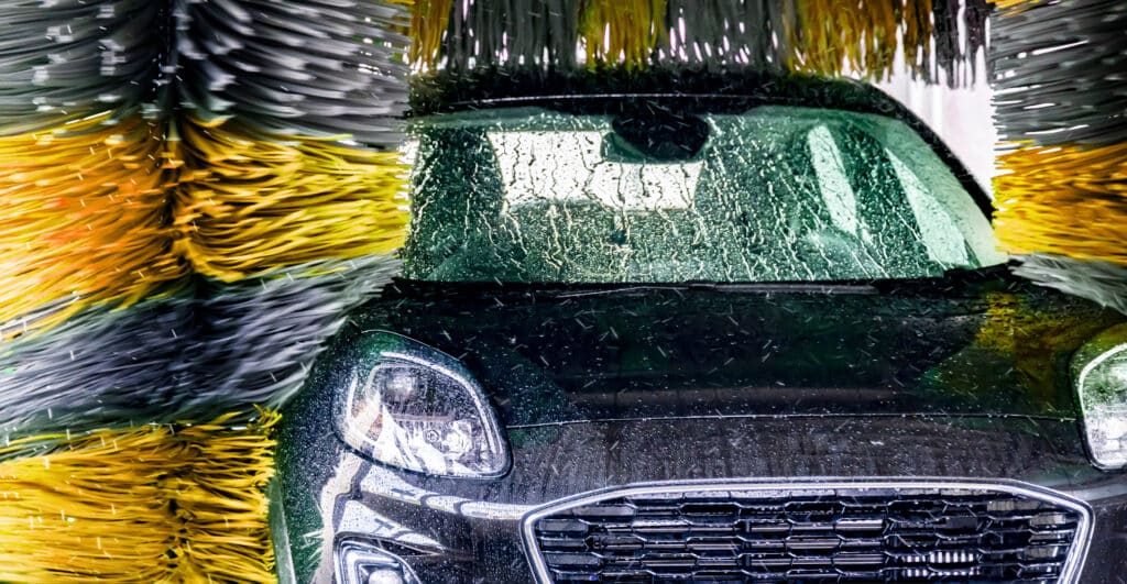 A vehicle in an automatic car wash.