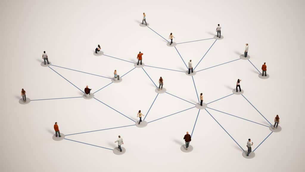 3D image of miniature people standing on a white surface, connected by thin blue lines. The people are arranged in a complex network, showcasing the interconnectedness of individuals and the intricate patterns of relationships.